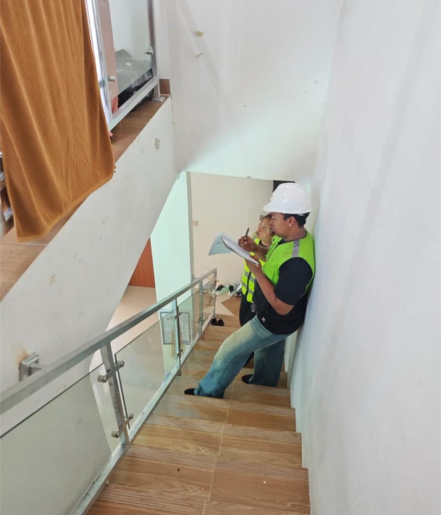 Field survey team recording observations on an existing stair.