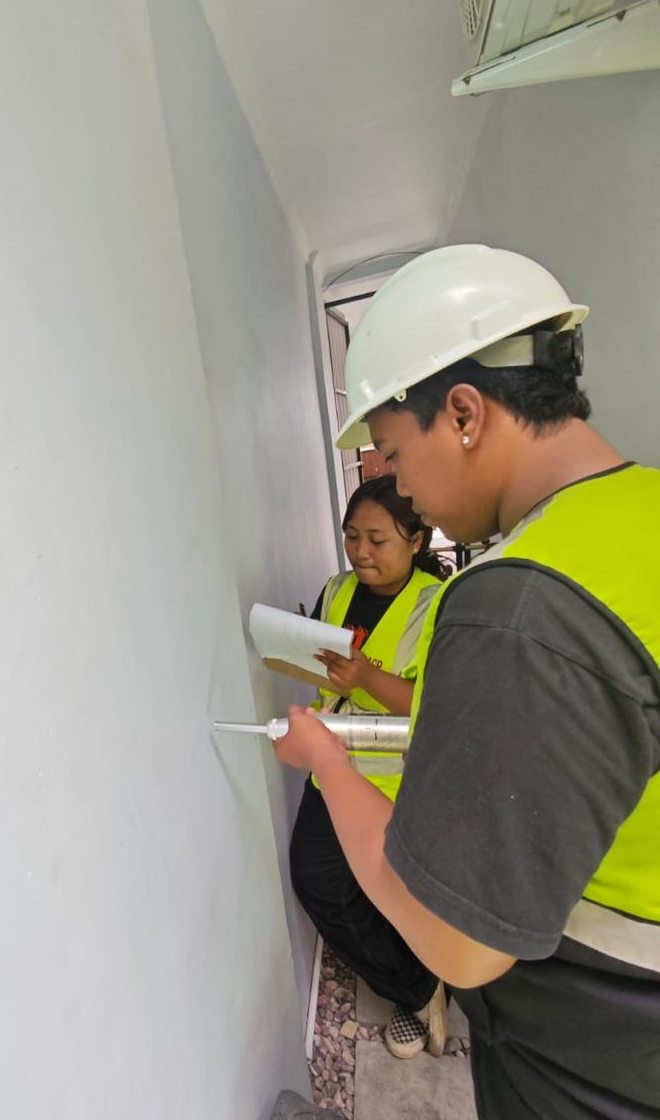 On-site measurement and verification along an existing exterior wall.